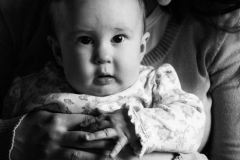 Black and White portraif of an infant daughter sitting on her mo